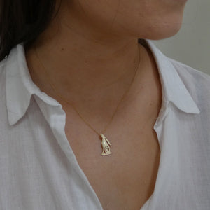 Woman wearing solid gold hare pendant with 9 carat gold chain