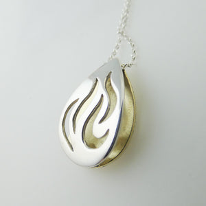 3d hollow pendant cut out silver flames backed with brass