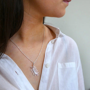Girl wearing silver fairy tree pendant