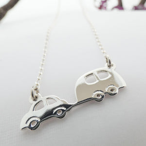 Silver necklace with car caravan